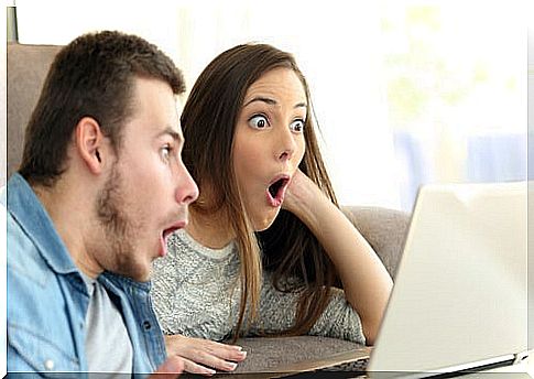 Couple with surprise looking at the computer