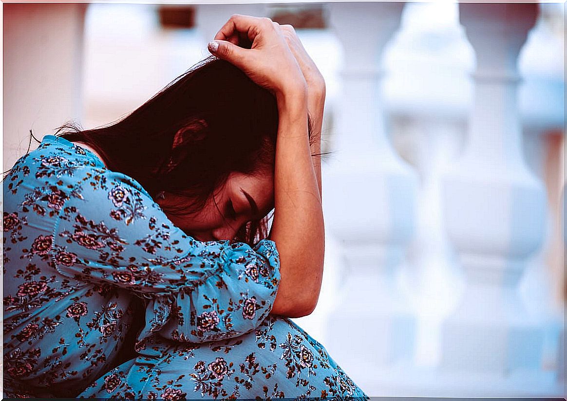 Sad woman sitting on the floor