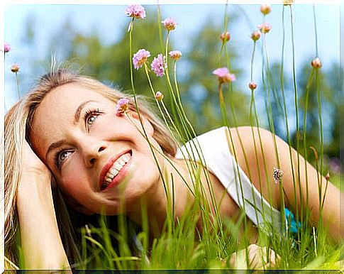 Woman smiling among flowers