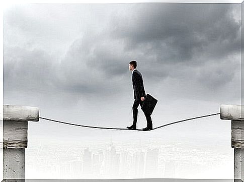 Man walking on a rope with confidence symbolizing attitudes that do not seem afraid