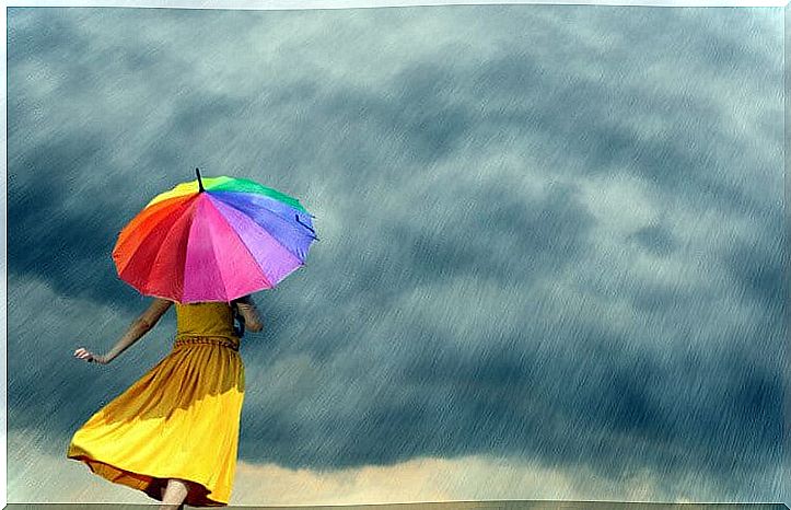 woman with colorful umbrella facing adversity