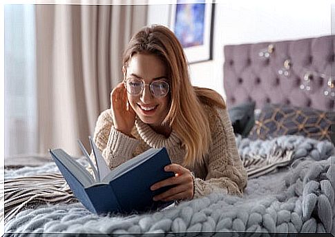 Woman reading book in her room