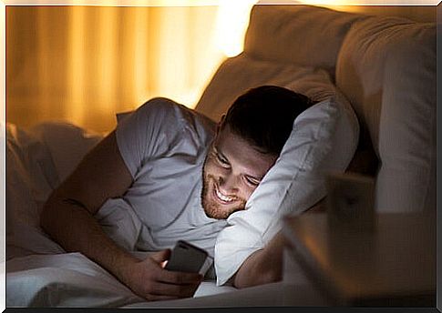 Man looking at mobile smiling