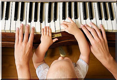 Mother with baby playing piano