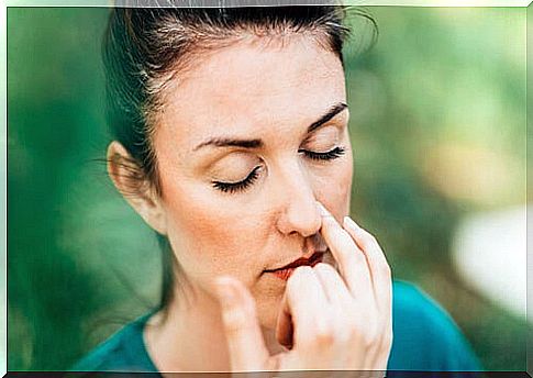 Woman with eyes closed while doing a yoga exercise