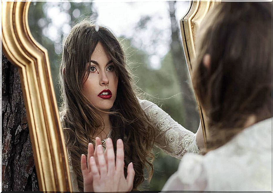 Woman looking in a mirror with an emptiness in her heart