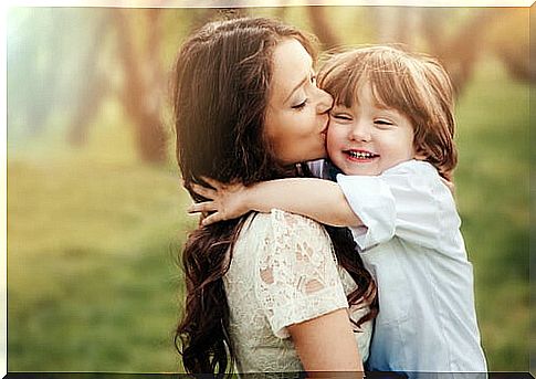 Mother giving her son a kiss