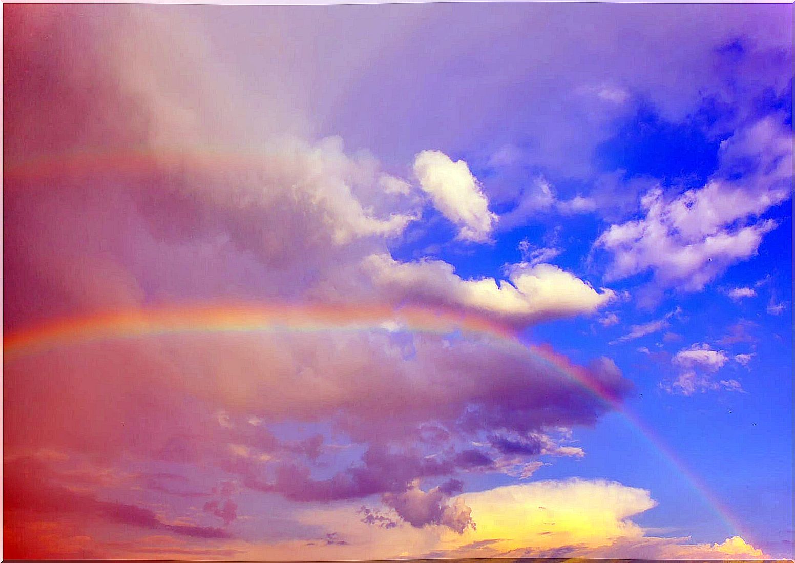 Rainbow between a rainy sky and a clear sky.