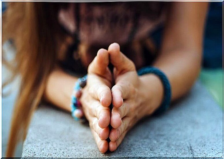 Woman with hands together expressing gratitude