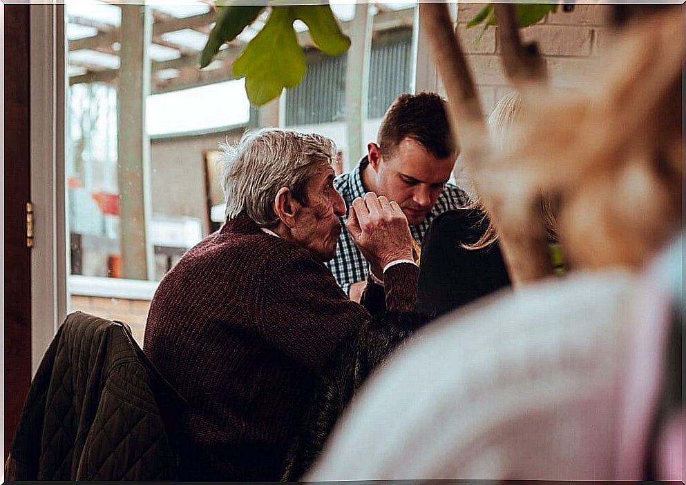 Senior father having breakfast with his son