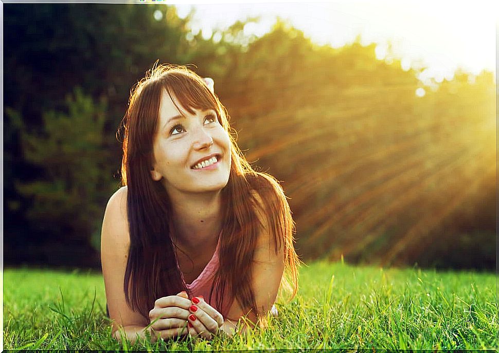 Woman looking up at the sun depicting the ancient Greek cure for depression and anxiety 