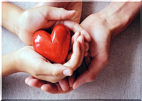 Hands holding a heart to represent the importance of caring