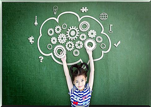 Little girl with brain drawn on a blackboard