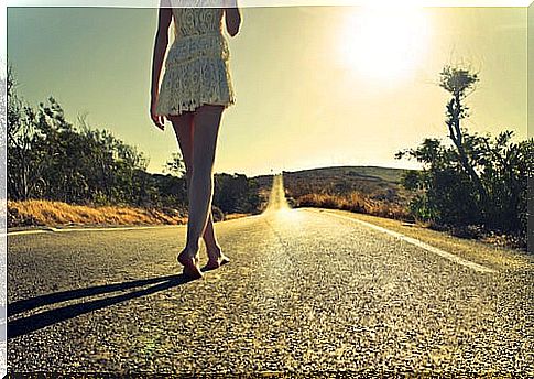 Woman walking alone on the road