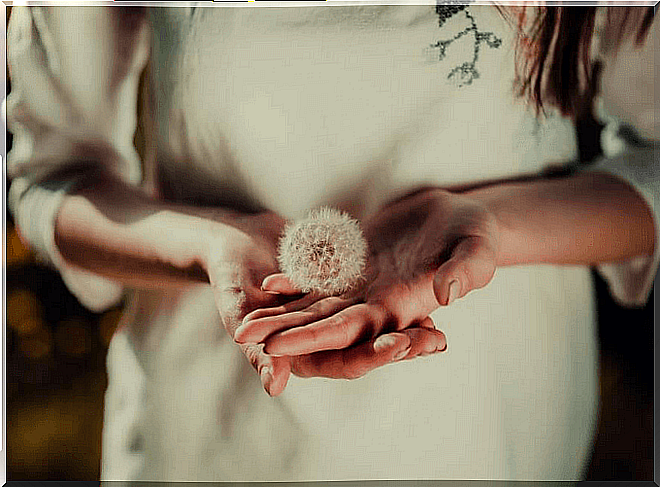 Woman with dandelion symbolizing today